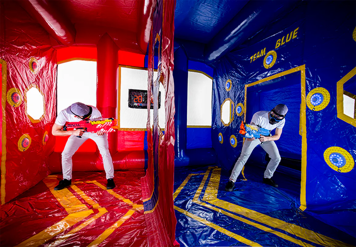 Two competitors facing off inside the red-and-blue IPS Rival Arena