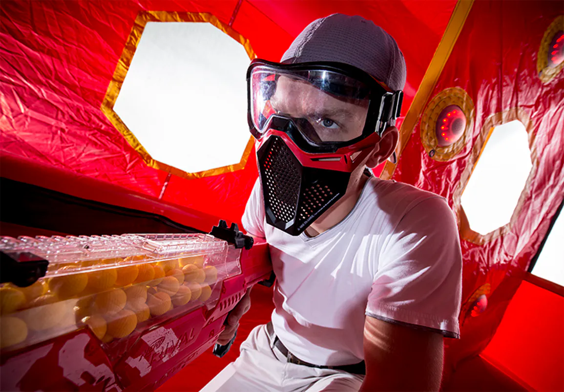 Competitor wearing protective eyewear with a soft foam-ball blaster