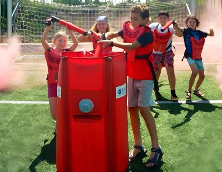 Children playing around a red Water Tag refill barrier