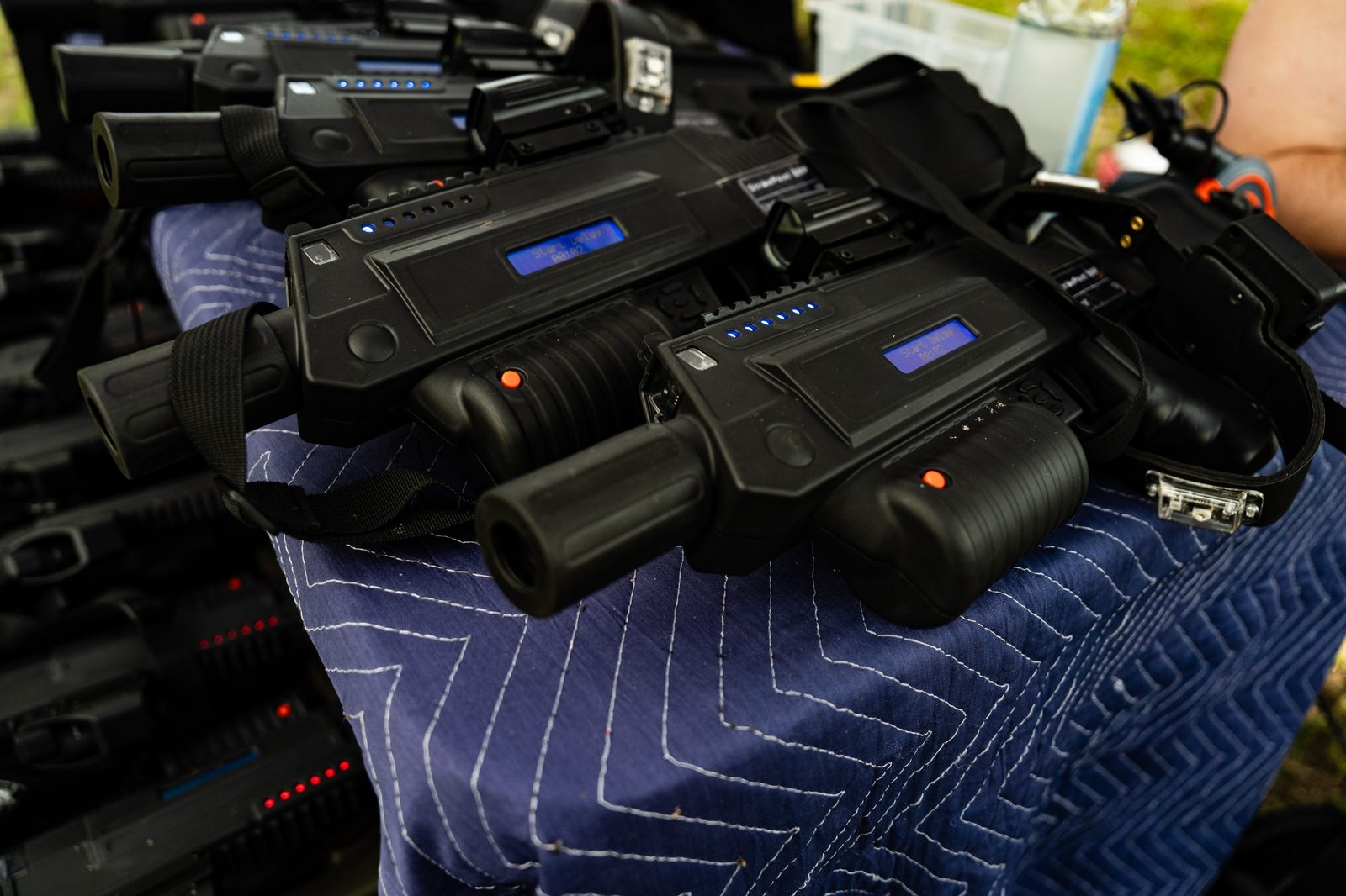 Several professional laser taggers and sensor headbands prepared for an event